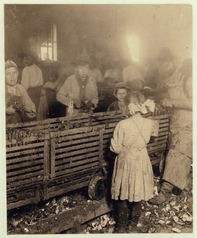 Factory of Lowden Canning Company, Bluffton, South Carolina showing a 7-year old girl who shucks 3 pots of oysters a day with her 6-year old brother and an 11-year old boy who does 6 pots by Lewis Wickes Hine